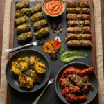 Food Forest Catering mixed kebab and starter platter with seekh kabab sesame bites chicken tikka and chilli chicken on slate board